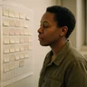 A project manager reading a programme chart on the wall